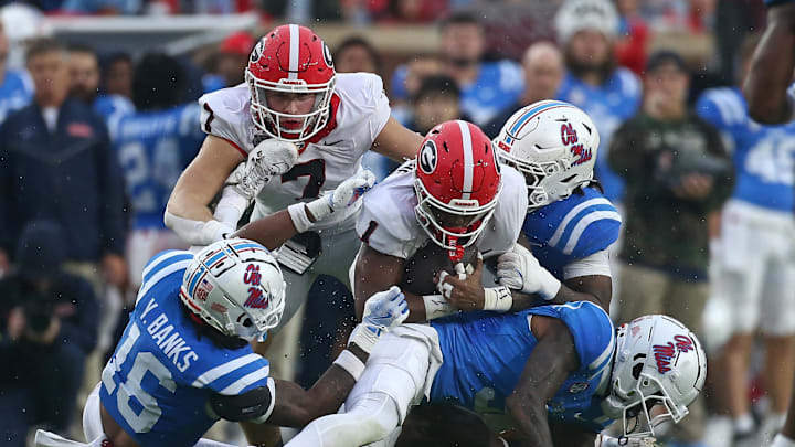 Nov 9, 2024; Oxford, Mississippi, USA; Georgia Bulldogs running back Trevor Etienne (1) runs the ball as Mississippi Rebels defensive back Trey Amos (9) makes the tackle during the first half at Vaught-Hemingway Stadium. Mandatory Credit: Petre Thomas-Imagn Images