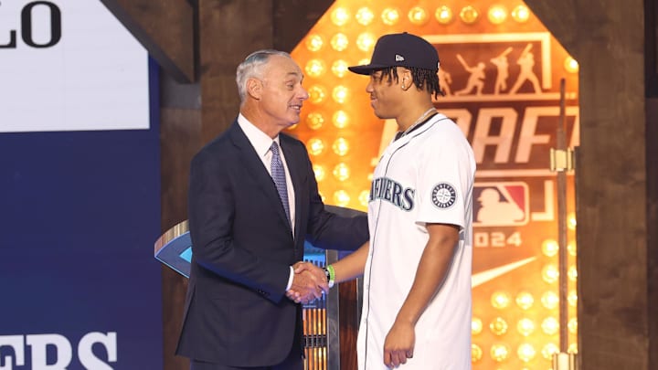 MLB Commissioner Rob Manfred takes a photo with Jurrangelo Cijntje after being drafted by the Seattle Mariners with the 15th pick during the first round of the MLB Draft at Cowtown Coliseum in 2024.