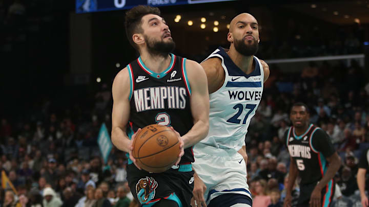 Jan 31, 2026; Memphis, Tennessee, USA; Memphis Grizzlies guard Ty Jerome (2) drives to the basket as Minnesota Timberwolves center Rudy Gobert (27) defends during the first quarter at FedExForum. Mandatory Credit: Petre Thomas-Imagn Images