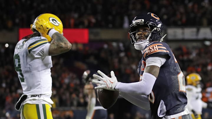 Bears cornerback Nahshon Wright throws the game ball into the crowd after teammate Kyler Gordon's pass defense on an incompletion ended a playoff victory over the Packers.