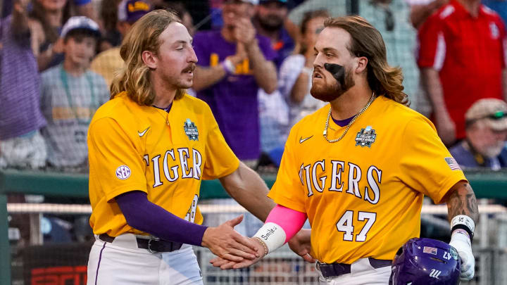Jun 24, 2023; Omaha, NE, USA; LSU Tigers third baseman Tommy White (47) and right fielder Paxton Kling (28) celebrate after a home run by White against the Florida Gators during the eighth inning at Charles Schwab Field Omaha. Mandatory Credit: Dylan Widger-USA TODAY Sports