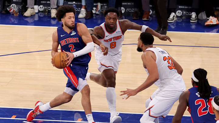 Jan 13, 2025; New York, New York, USA; Detroit Pistons guard Cade Cunningham (2) drives to the basket against New York Knicks forward OG Anunoby (8) and center Karl-Anthony Towns (32) during the fourth quarter at Madison Square Garden. Mandatory Credit: Brad Penner-Imagn Images