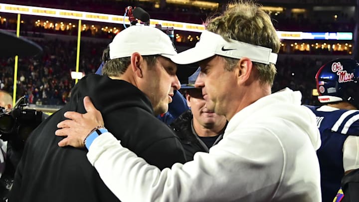 Mississippi State Bulldogs head coach Jeff Lebby and Mississippi Rebels head coach Lane Kiffin shake hands after the game at Vaught-Hemingway Stadium.