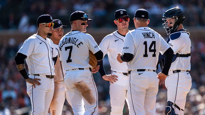 Detroit Tigers players stand on the pitching mound. Detroit Tigers players stand on the pitching mound.