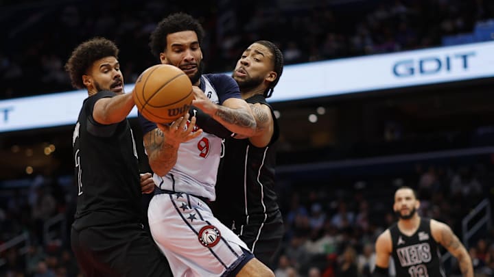 Feb 24, 2025; Washington, District of Columbia, USA; Washington Wizards forward Justin Champagnie (9) battles for the ball with Brooklyn Nets forward Cameron Johnson (2) and Nets forward Trendon Watford (9) in the second half at Capital One Arena. Mandatory Credit: Geoff Burke-Imagn Images