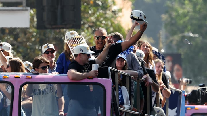 Nov 1, 2024; Los Angeles, CA, USA;  Los Angeles Dodgers manager Dave Roberts celebrates with the Commissioner’s Trophy during the 2024 World Series Championship parade in downtown Los Angeles.  Mandatory Credit: Kiyoshi Mio-Imagn Images