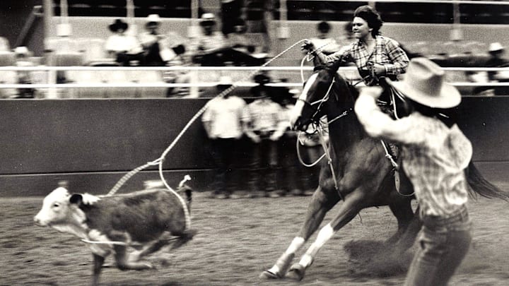 Lari Dee Guy ropes a calf in August 1984 in Abilene, Texas. Lari Dee Guy ropes a calf in August 1984 in Abilene, Texas.