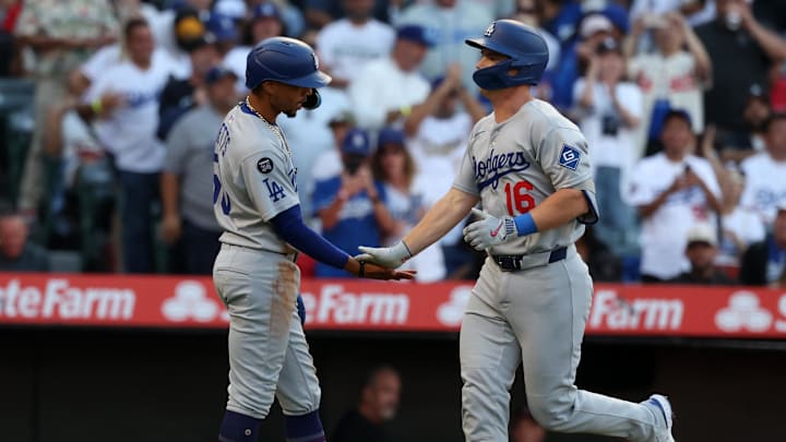Aug 13, 2025; Anaheim, California, USA;  Los Angeles Dodgers catcher Will Smith (16) is greeted by shortstop Mookie Betts (50, left) after hitting a two-run home run during the first inning against the Los Angeles Angels at Angel Stadium. Mandatory Credit: Kiyoshi Mio-Imagn Images