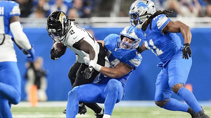 Nov 17, 2024; Detroit, MI, USA; Detroit Lions linebacker Malcolm Rodriguez (44) stops Jacksonville Jaguars running back D'Ernest Johnson (2) during the first half at Ford Field in Detroit on Sunday, Nov. 17, 2024. Mandatory Credit: Junfu Han/USA TODAY Network via Imagn Images 