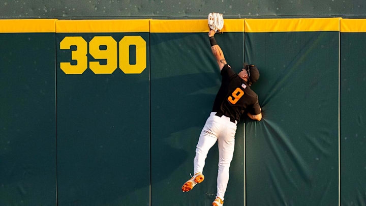 Tennessee's Hunter Ensley (9) makes a home run-robbing catch at the top of the wall during a college baseball game between Tennessee and Vanderbilt at Lindsey Nelson Stadium in Knoxville, Tenn., on May 9, 2025. Tennessee's Hunter Ensley (9) makes a home run-robbing catch at the top of the wall during a college baseball game between Tennessee and Vanderbilt at Lindsey Nelson Stadium in Knoxville, Tenn., on May 9, 2025.