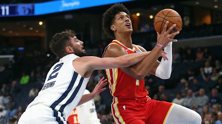 Oct 11, 2025; Memphis, Tennessee, USA; Atlanta Hawks forward Jalen Johnson (1) drives to the basket as Memphis Grizzlies guard Ty Jerome (2) defends during the first quarter at FedExForum. Mandatory Credit: Petre Thomas-Imagn Images