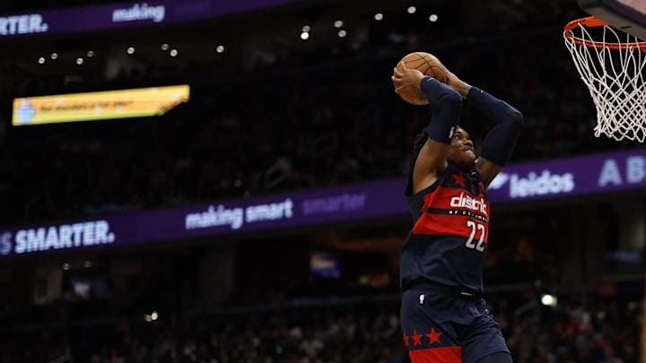 Feb 21, 2025; Washington, District of Columbia, USA; Washington Wizards forward Richaun Holmes (22) dunks the ball as Milwaukee Bucks guard Gary Trent Jr. (5) looks on in the second half at Capital One Arena. Mandatory Credit: Geoff Burke-Imagn Images