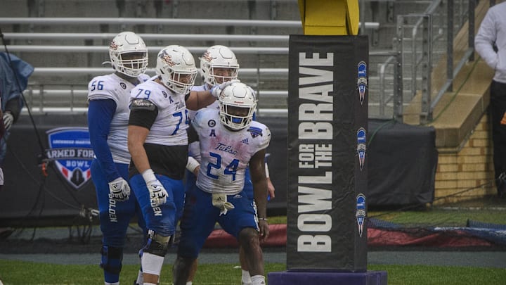 Dec 31, 2020; Fort Worth, TX, USA; Tulsa Golden Hurricane quarterback Zach Smith (11) and running back Corey Taylor II (24) and offensive lineman Jaden Muskrat (79) and offensive lineman Tyler Smith (56) celebrate a touchdown against the Mississippi State Bulldogs during the second half at Amon G. Carter Stadium. Mandatory Credit: Jerome Miron-Imagn Images