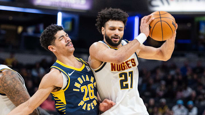 Feb 24, 2025; Indianapolis, Indiana, USA; Denver Nuggets guard Jamal Murray (27) dribbles the ball while Indiana Pacers guard Ben Sheppard (26) defends in the second half at Gainbridge Fieldhouse. Mandatory Credit: Trevor Ruszkowski-Imagn Images