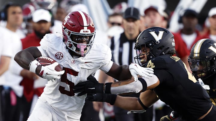 Oct 5, 2024; Nashville, Tennessee, USA;  Alabama Crimson Tide wide receiver Germie Bernard (5) runs the ball against Vanderbilt Commodores linebacker Bryan Longwell (4) after a reception for a first down during the second half at FirstBank Stadium. Mandatory Credit: Butch Dill-Imagn Images