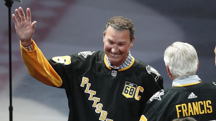 Feb 18, 2024; Pittsburgh, Pennsylvania, USA;  Pittsburgh Penguins former center Mario Lemieux gestures to the crowd during a ceremony to retire the jersey number of Penguins former right wing Jaromir Jagr (not pictured) at PPG Paints Arena. The Penguins host the Los Angeles Kings after the ceremony. Mandatory Credit: Charles LeClaire-Imagn Images