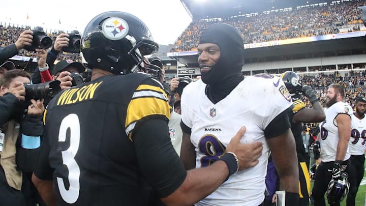 Nov 17, 2024; Pittsburgh, Pennsylvania, USA;  Pittsburgh Steelers quarterback Russell Wilson (3) and Baltimore Ravens quarterback Lamar Jackson (8) meet at mid-field after playing at Acrisure Stadium. Mandatory Credit: Charles LeClaire-Imagn Images
