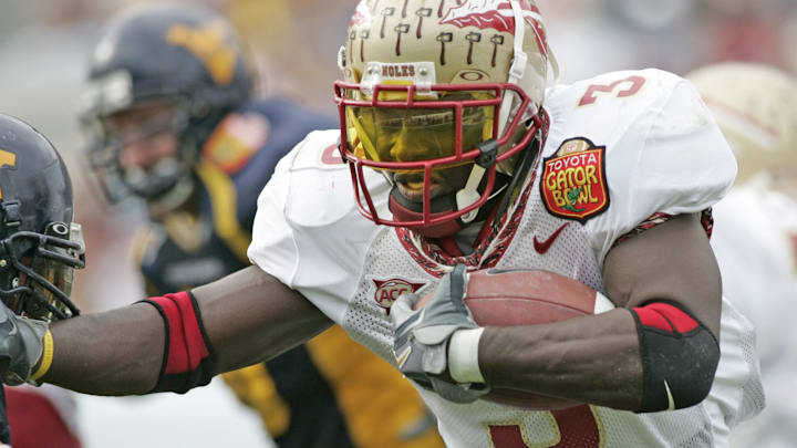 Jan 01, 2005; Jacksonville, FL, USA;  Florida State Seminoles runningback Leon Washington runs past a West Virginia Mountaineers defender in the 2005 Toyota Gator Bowl held at Alltel Stadium. FSU defeated West Virginia 30-18. Mandatory Credit: Photo by Imagn Images (©) Copyright 2004 by Preston Mack