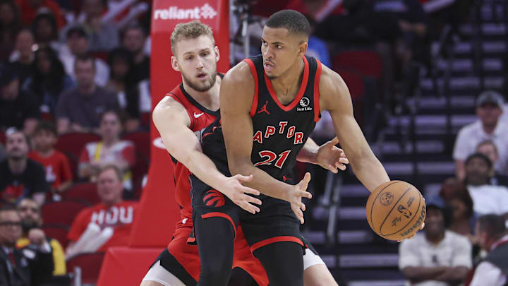 Feb 9, 2025; Houston, Texas, USA; Houston Rockets center Jock Landale (2) defends against Toronto Raptors center Orlando Robinson (21) during the fourth quarter at Toyota Center. Mandatory Credit: Troy Taormina-Imagn Images