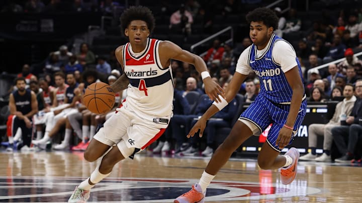 Nov 1, 2025; Washington, District of Columbia, USA; Washington Wizards guard AJ Johnson (4) drives to the basket as Orlando Magic guard Jase Richardson (11) defends in the second half at Capital One Arena. Mandatory Credit: Geoff Burke-Imagn Images