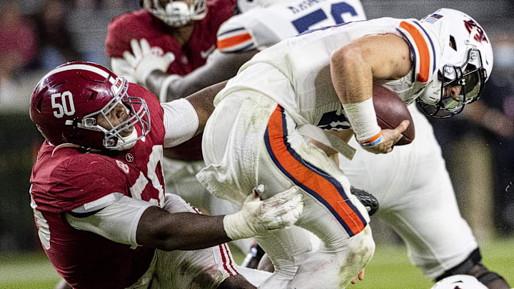 Nov 28, 2020; Tuscaloosa, Alabama, USA;  Alabama defensive lineman Tim Smith (50) hits Auburn quarterback Bo Nix (10) at Bryant-Denny Stadium in the Iron Bowl.