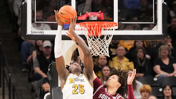 Feb 25, 2025; Columbia, Missouri, USA; Missouri Tigers guard Mark Mitchell (25) shoots as South Carolina Gamecocks forward Jordan Butler (0) defends during the second half at Mizzou Arena. Mandatory Credit: Denny Medley-Imagn Images
