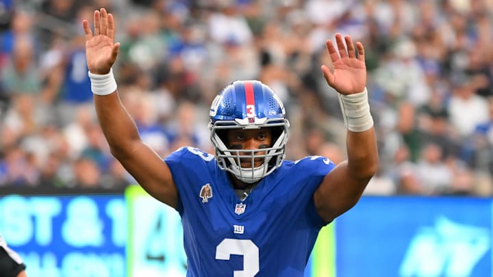 Aug 16, 2025; East Rutherford, New Jersey, USA; New York Giants quarterback Russell Wilson (3) gestures for a touchdown against the New York Jets during the first half during the first half at MetLife Stadium.