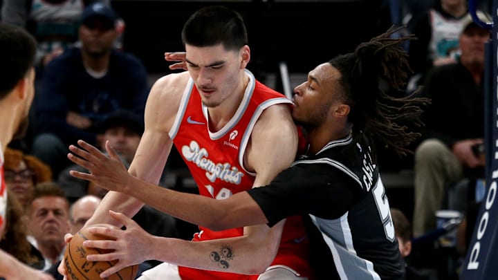 Mar 1, 2025; Memphis, Tennessee, USA; Memphis Grizzlies center Zach Edey (14) handles the ball as San Antonio Spurs guard Stephon Castle (5) defends Mar 1, 2025; Memphis, Tennessee, USA; Memphis Grizzlies center Zach Edey (14) handles the ball as San Antonio Spurs guard Stephon Castle (5) defends