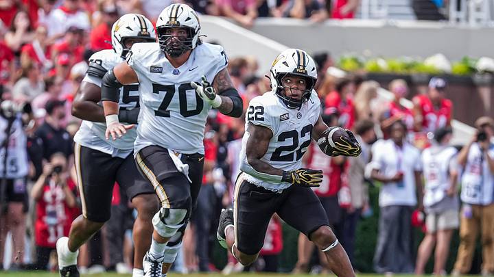 Oct 3, 2026; Athens, Georgia, USA; Vanderbilt Commodores running back Makhilyn Young (22) runs behind offensive lineman Cade McConnell (70) against the Georgia Bulldogs at Sanford Stadium. Mandatory Credit: Dale Zanine-Imagn Images Oct 3, 2026; Athens, Georgia, USA; Vanderbilt Commodores running back Makhilyn Young (22) runs behind offensive lineman Cade McConnell (70) against the Georgia Bulldogs at Sanford Stadium. Mandatory Credit: Dale Zanine-Imagn Images