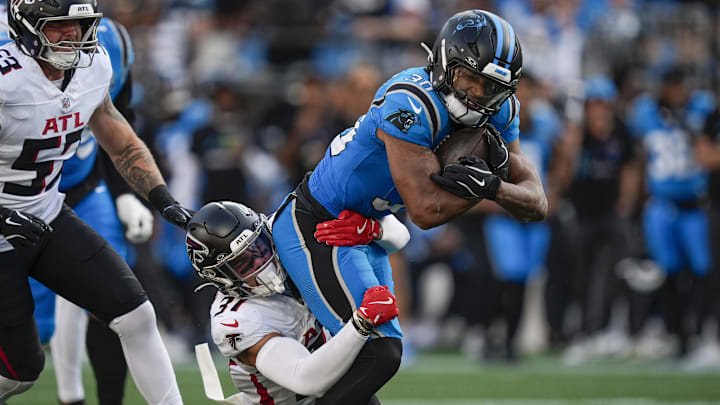 Oct 13, 2024; Charlotte, North Carolina, USA; Carolina Panthers running back Chuba Hubbard (30) is tackled by Atlanta Falcons safety Justin Simmons (31) during the second quarter at Bank of America Stadium. 
