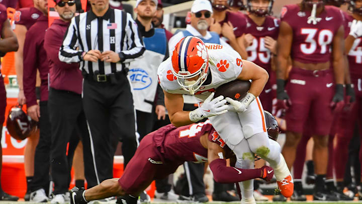 Nov 9, 2024; Blacksburg, Virginia, USA; Virginia Tech Hokies cornerback Mansoor Delane (4) tackles Clemson Tigers tight end Jake Briningstool (9) during the second quarter at Lane Stadium. Mandatory Credit: Brian Bishop-Imagn Images Nov 9, 2024; Blacksburg, Virginia, USA; Virginia Tech Hokies cornerback Mansoor Delane (4) tackles Clemson Tigers tight end Jake Briningstool (9) during the second quarter at Lane Stadium. Mandatory Credit: Brian Bishop-Imagn Images