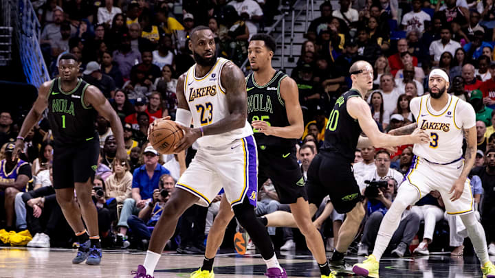 Apr 14, 2024; New Orleans, Louisiana, USA; Los Angeles Lakers forward LeBron James (23) looks to pass the ball against New Orleans Pelicans guard Trey Murphy III (25) during the first half at Smoothie King Center. Mandatory Credit: Stephen Lew-Imagn Images