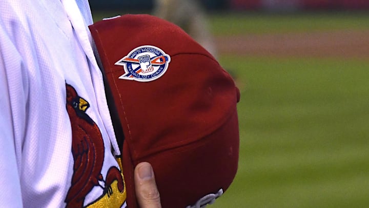 Sep 11, 2018; St. Louis, MO, USA; St. Louis Cardinals manager Mike Shildt (8) and his team wear patches on their hats in remembrance of the victims of the terrorist attacks on September 11, 2001 prior to a game against the Pittsburgh Pirates at Busch Stadium. Mandatory Credit: Jeff Curry-Imagn Images
