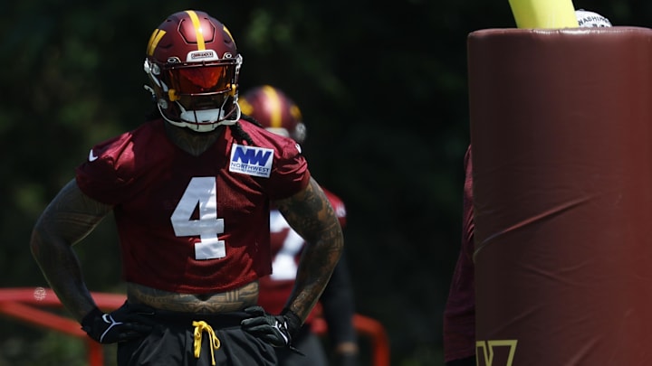 Washington Commanders linebacker Frankie Luvu stands on the field during drills on day one of minicamp.