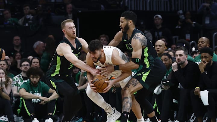 Feb 28, 2025; Boston, Massachusetts, USA; Cleveland Cavaliers guard Ty Jerome (2) tries to get away from Boston Celtics forward Jayson Tatum (0) and forward Sam Hauser (30) during the first quarter at TD Garden. Mandatory Credit: Winslow Townson-Imagn Images