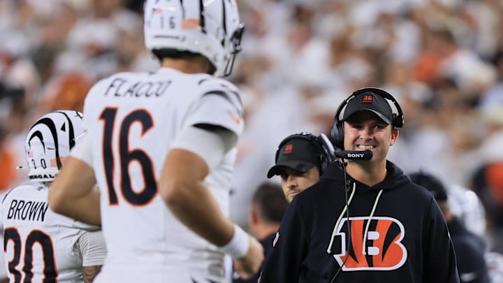 Oct 16, 2025; Cincinnati, Ohio, USA; Cincinnati Bengals head coach Zac Taylor smiles at quarterback Joe Flacco (16) (obscured) as Flacco runs to the sideline during the fourth quarter against the Pittsburgh Steelers at Paycor Stadium. Mandatory Credit: Katie Stratman-Imagn Images