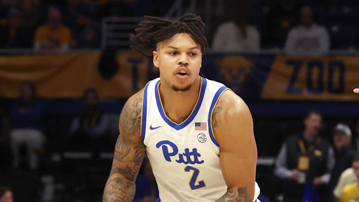 Jan 10, 2026; Pittsburgh, Pennsylvania, USA;  Pittsburgh Panthers forward Cameron Corhen (2) dribbles the ball against Syracuse Orange forward William Kyle III (42)  during the first half at the Petersen Events Center. Mandatory Credit: Charles LeClaire-Imagn Images