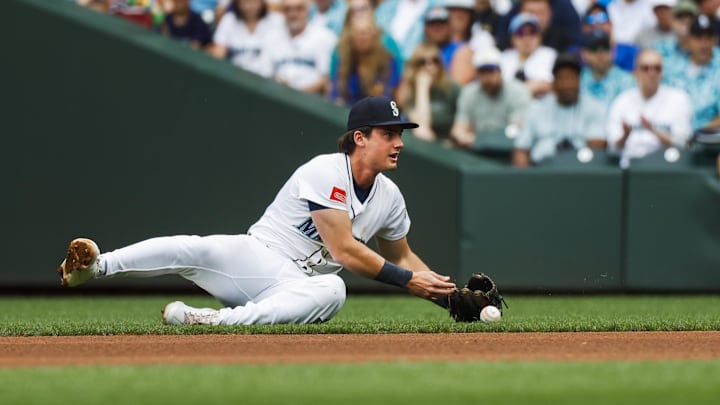 Aug 2, 2025; Seattle, Washington, USA; Seattle Mariners second baseman Cole Young (2) bobbles the transfer to his throwing hand after fielding a ground ball against the Texas Rangers during the third inning at T-Mobile Park. The play was ruled an infield single. Mandatory Credit: Joe Nicholson-Imagn Images
