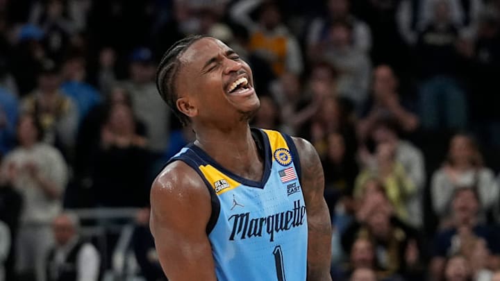 Marquette Golden Eagles guard Kam Jones (1) assists and reacts to the dunk from Marquette Golden Eagles forward Damarius Owens (10) during the second half of the game against Providence on Tuesday February 25, 2025 at Fiserv Forum in Milwaukee, Wis.