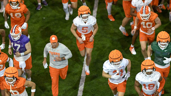 Clemson head coach Dabo Swinney and the team run from indoors to outside during the first football practice at the Allen N. Reeves Football Complex at Clemson University in Clemson, S.C. Friday, February 28, 2025.