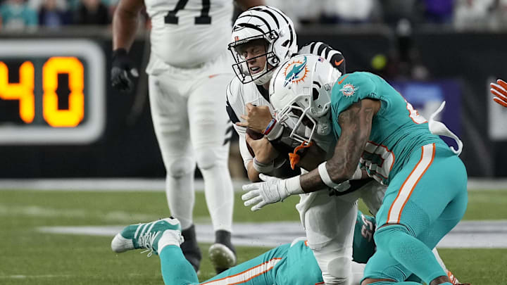 Cincinnati Bengals quarterback Joe Burrow (9) takes a hit against the Miami Dolphins in a 2022 game.