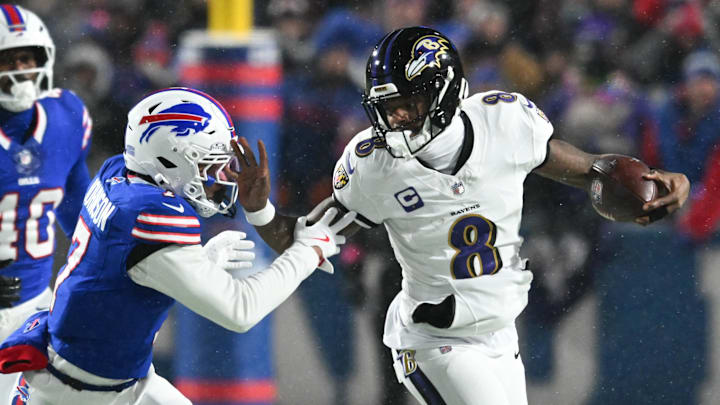 Baltimore Ravens quarterback Lamar Jackson (8) runs the ball against Buffalo Bills cornerback Taron Johnson (7) during the first quarter in a 2025 AFC divisional round game at Highmark Stadium. 