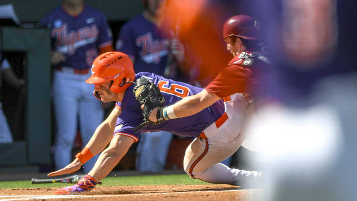 Mar 1, 2025; Greenville, South Carolina, USA; Clemson Tigers outfielder Dominic Listi (6) is tagged out at home plate by South Carolina catcher Talmadge LeCroy (5) during the top of the first inning at Fluor Field. Mandatory Credit: Ken Ruinard/USA Today Network via Imagn Images