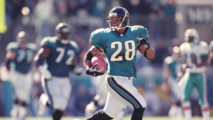 01/15/00.-- Bob Self/staff-- Fred Taylor takes a look back after breaking off a 90-yard touchdown run in the 1st quarter.
