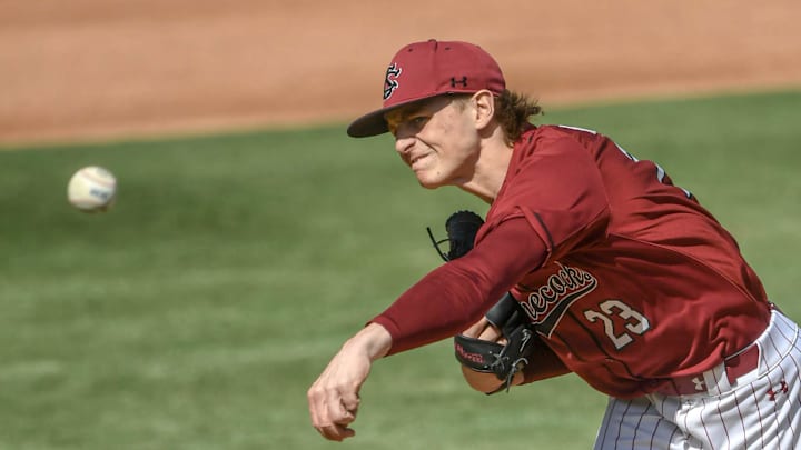 Mar 1, 2025; Greenville, South Carolina, USA; South Carolina Gamecocks pitcher Jake McCoy (23) throws to the Clemson Tigers during the top of the first inning at Fluor Field. Mandatory Credit: Ken Ruinard/USA Today Network via Imagn Images