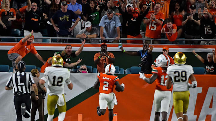 Nov 11, 2017; Miami Gardens, FL, USA; Miami Hurricanes defensive back Trajan Bandy (2) runs into the end zone to score a touchdown after intercepting a pass from Notre Dame Fighting Irish quarterback Ian Book (12) during the first half at Hard Rock Stadium. Mandatory Credit: Jasen Vinlove-Imagn Images
