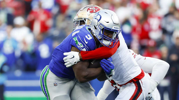 Oct 10, 2024; Seattle, Washington, USA; San Francisco 49ers cornerback Deommodore Lenoir (2) tackles Seattle Seahawks running back Kenneth Walker III (9) during the first quarter at Lumen Field. Mandatory Credit: Joe Nicholson-Imagn Images Oct 10, 2024; Seattle, Washington, USA; San Francisco 49ers cornerback Deommodore Lenoir (2) tackles Seattle Seahawks running back Kenneth Walker III (9) during the first quarter at Lumen Field. Mandatory Credit: Joe Nicholson-Imagn Images