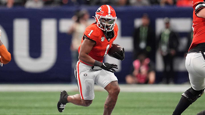 Dec 7, 2024; Atlanta, GA, USA; Georgia Bulldogs running back Trevor Etienne (1) rushes the ball against the Texas Longhorns during the first half in the 2024 SEC Championship game at Mercedes-Benz Stadium. Mandatory Credit: Dale Zanine-Imagn Images