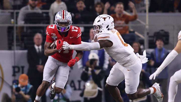Jan 10, 2025; Arlington, Texas, USA; Ohio State Buckeyes wide receiver Carnell Tate (17) runs against Texas Longhorns linebacker Anthony Hill Jr. (0) during the first quarter of the College Football Playoff semifinal in the Cotton Bowl at AT&T Stadium. Mandatory Credit: Tim Heitman-Imagn Images