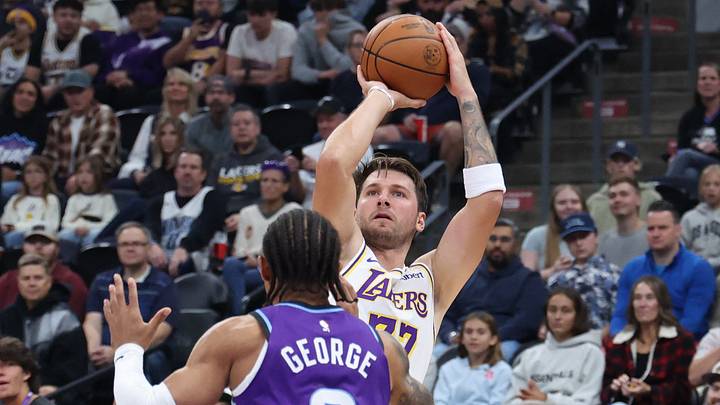 Oct 25, 2026; Salt Lake City, Utah, USA;  Los Angeles Lakers guard Luka Doncic (77) shoots over Utah Jazz guard Keyonte George (3) during the first half at Delta Center.  Mandatory Credit: Rob Gray-Imagn Images